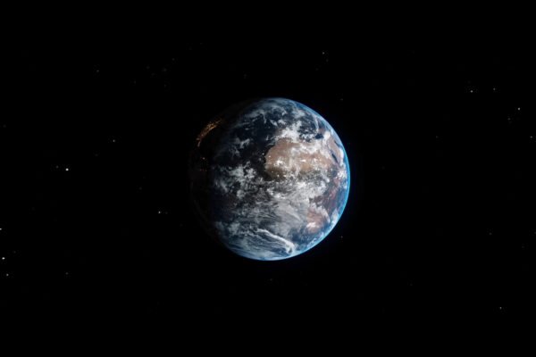 Earth depicted in space, showcasing its blue oceans and green landmasses against a black background, symbolising global perspective.