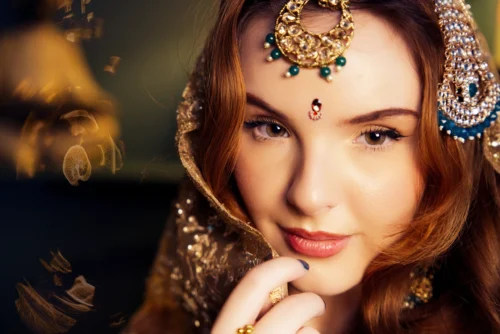A woman in traditional attire with a decorative headpiece and makeup, showcasing cultural beauty in commercial photography.