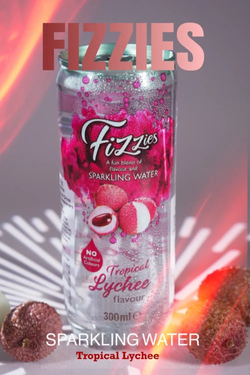 Fizzies sparkling water can, Tropical Lychee flavour, with lychee fruits in the foreground, highlighting a vibrant and refreshing drink.