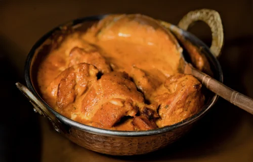 Rich, creamy chicken curry served in a traditional bowl, showcasing the artistry of food photography.